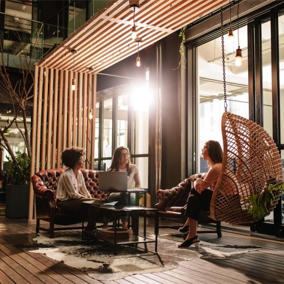 Team collaborating in a modern workspace lounge